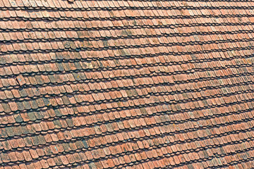 vintage roof covered with wooden red tile heap, construction technology