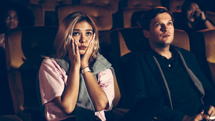 People audience watching movie in cinema theater.