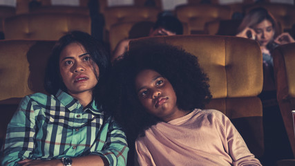 People audience watching movie in cinema theater.