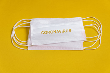 Surgical mask over minimalist orange background