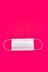 Surgical mask over minimalist orange background