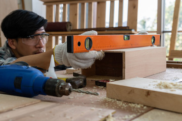 Carpenter working on wood craft at workshop