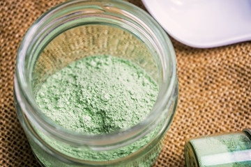 Mitragyna speciosaor Kratom powder in ceramic spoon and glass jars