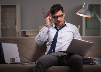 Businessman workaholic working late at home