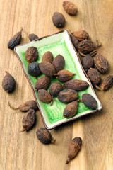 heap of black cardamom whole seeds 