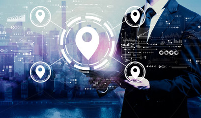 Fototapeta premium Map pin concept with businessman holding a tablet computer