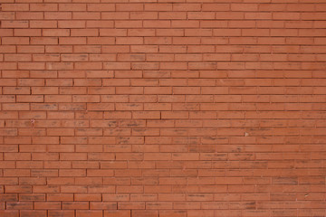 Vintage burnt orange color brick wall background with grungy texture