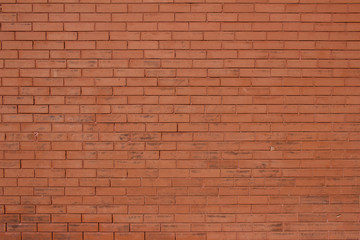 Vintage burnt orange color brick wall background with grungy texture