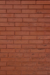 Vintage burnt orange color brick wall background with grungy texture