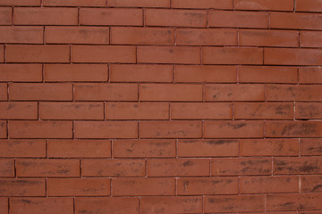 Vintage burnt orange color brick wall background with grungy texture