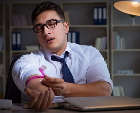 Businessman Staying Late In Office For Drugs