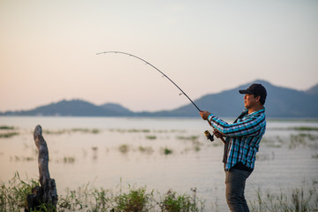 Office man self quarantine in with the nature by fishing in the lake. Quarantine concept