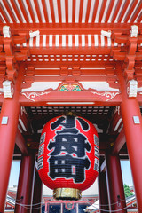 Giant red paper lamp with kanjis and ceiling at the Hozomon gate of Senso-ji temple, Asakusa, Japan
