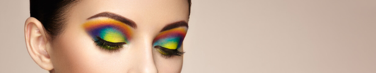 Female eye with  rainbow make-up.  Long eyelashes, vivid colorful eyeshadows. Beauty. Close up, Macro