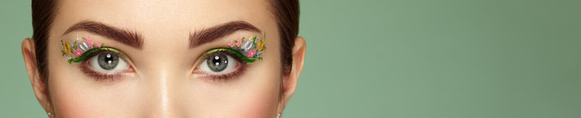 Female eye with flower makeup eyes. Spring makeup. Beauty fashion. Eyelashes. Cosmetic Eyeshadow....