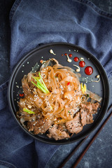 Asian Cuisine, Spicy Asian Beef Noodles on dark background
