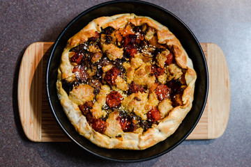 plant-based food recipes, vegan pie with pumpkin zucchini and roasted cherry tomatoes and vegan cream cheese just out of the oven