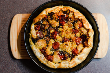 plant-based food recipes, vegan pie with pumpkin zucchini and roasted cherry tomatoes and vegan cream cheese just out of the oven
