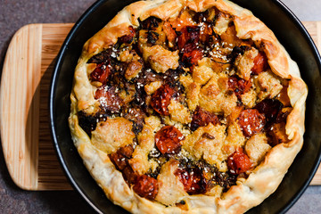 plant-based food recipes, vegan pie with pumpkin zucchini and roasted cherry tomatoes and vegan cream cheese just out of the oven