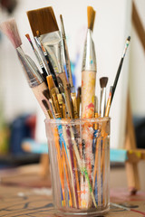 Used paint brushes in glass