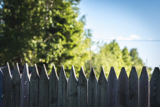 Wooden fence made of stockade to protect the territory.