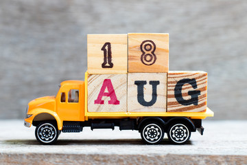Truck hold letter block in word 18aug on wood background (Concept for date 18 month August)
