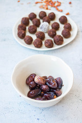 Iranian dates and protein energy balls with cocoa, carob, chocolate, coconut, oatmeal. Dark vegan truffles sweets. Healthy dessert
