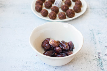 Iranian dates and protein energy balls with cocoa, carob, chocolate, coconut, oatmeal. Dark vegan truffles sweets. Healthy dessert