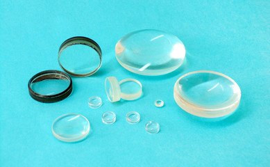 Magnifying lenses close- up on a blue background. Spare parts for optical devices. Optical lens magnifier made of glass and plastic.