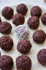Protein energy balls with cocoa, carob, chocolate, coconut, dates, oatmeal. Dark vegan truffles sweets. Healthy dessert
