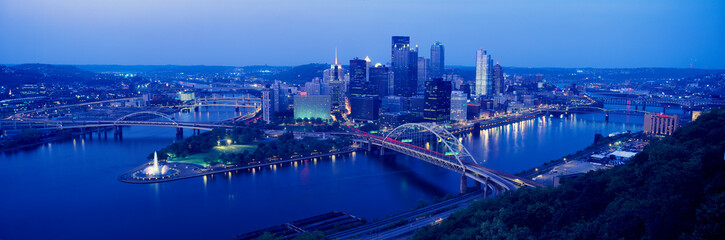 Panoramic evening view of Pittsburgh, PA with West End Bridge, and Allegheny, Monongahela and Ohio Rivers