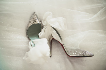 Close up of bridal wedding shoes, on a bride veil