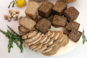 Different varieties of bread on the kitchen table on a light background top view