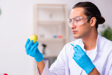 Young male nutrition expert testing food products in lab