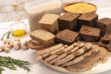Different varieties of bread on the kitchen table on a light background