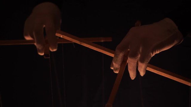 Puppet master and marionettes. Manipulations with the mind and actions of people concept