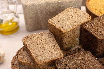 Different varieties of bread on the kitchen table on a light background top view