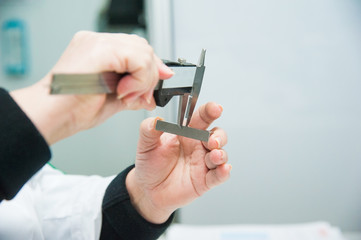 Mechanical technician worker measuring detail tool