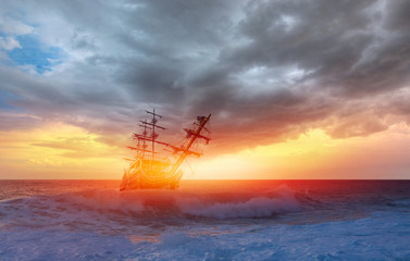 Sailing ship in storm sea on the foreground power sea wave