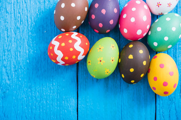 Easter eggs top view on blue wooden background