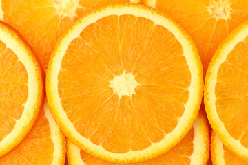 Fresh orange slices close up background. Juicy sun orange macro shot. 
