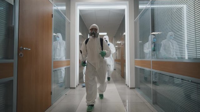 Specialists disinfecting empty office during quarantine of coronavirus
