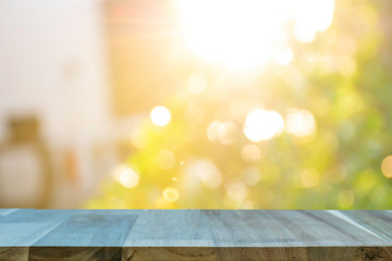 Display the product on a wooden table. The bokeh background from the sun is passing through the leaves