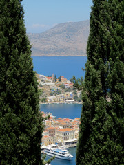 Tourism - View of the bay of mediterranian island. View of the bay between two Thujas.