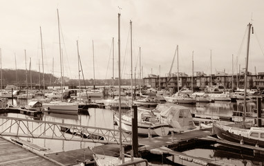 Harbor with sailboats and yachts moored in the port.