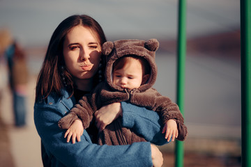 Mother and Baby Squinting from Sunlight 