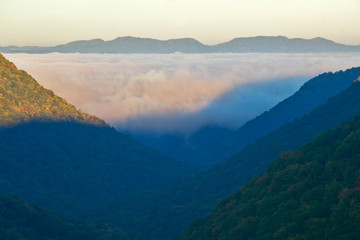 Morning fog at sunrise in autumn mountains of West Virginia in Babcock State Park
