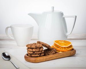 Oatmeal cookies with chocolate and candied fruits on wooden plate