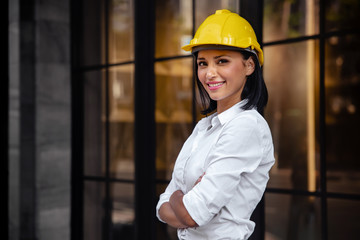 Portrait of a Confident Construction Engineer Woman. Smiling and Looking at Camera. Standing in...