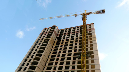 Construction building and construction crane on blue sky background